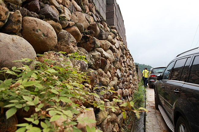 油石鄉(xiāng)梅嶺小學(xué)路口較窄，車隊只能停在路邊，步行上去